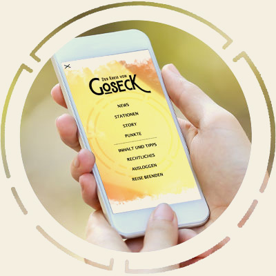 Ein Handy mit der Webapp 'Der Kreis von Goseck' auf dem Bildschirm.